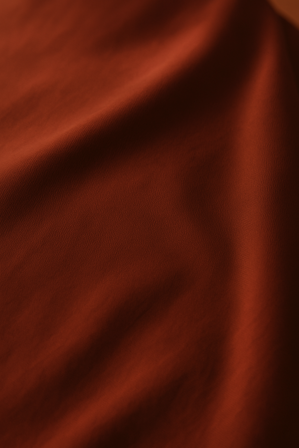 Close-up of terracotta Austrian micromodal fabric, silky-soft, breathable, and sustainably made from beech trees.