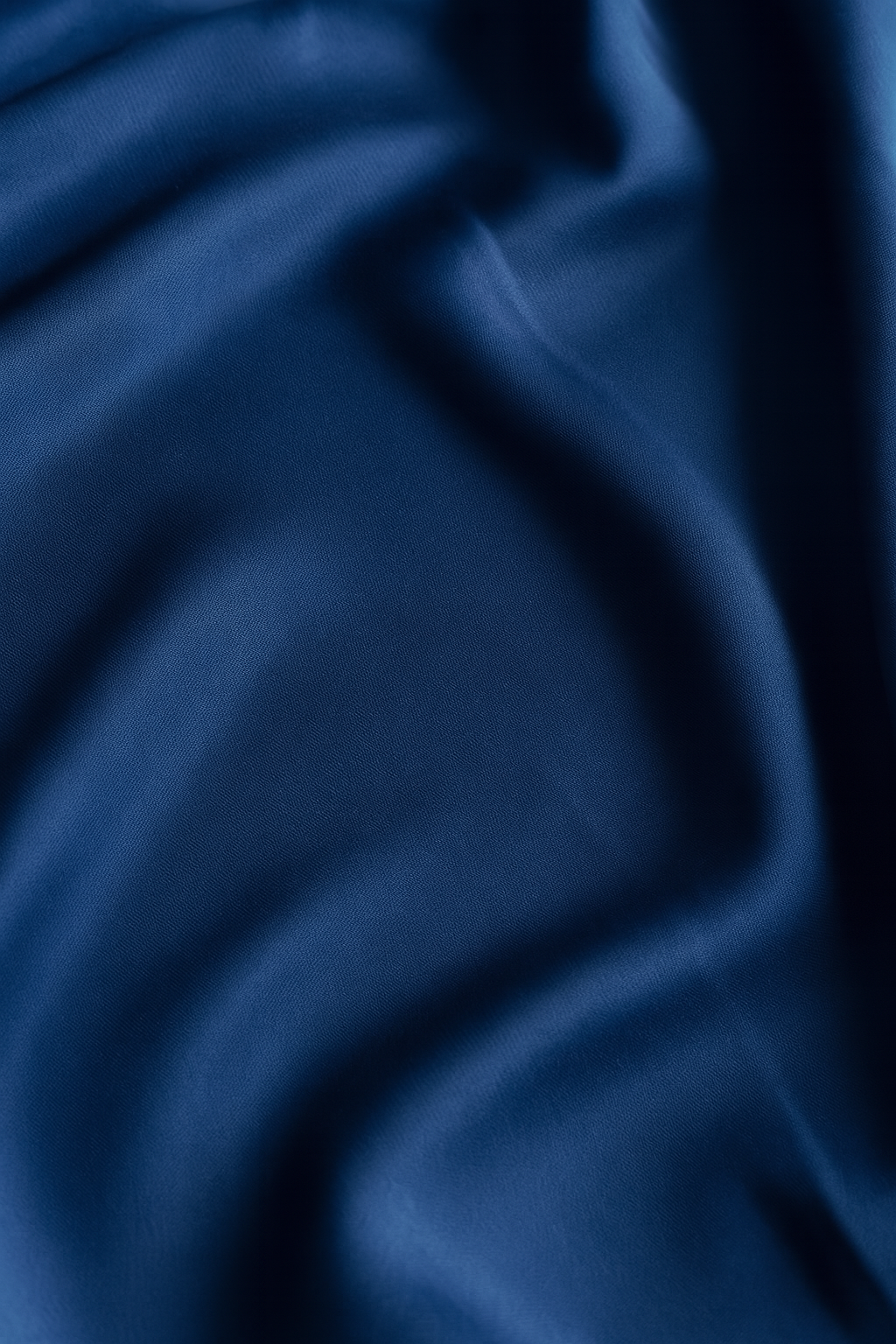 Close-up of deep navy Italian regenerated ECONYL® nylon, crafted from rescued ocean plastics for strength and durability.