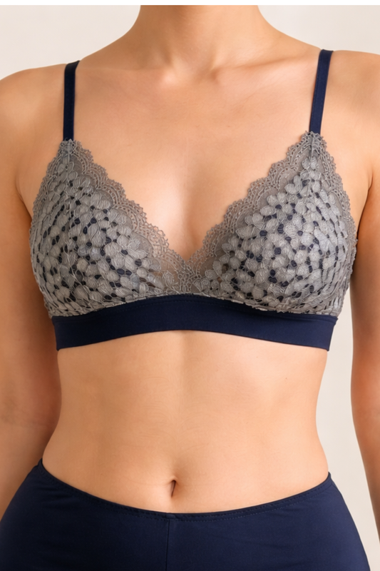 Front view of an airy navy wire-free lace bralette with soft triangle cups and delicate lace, designed for smaller busts.