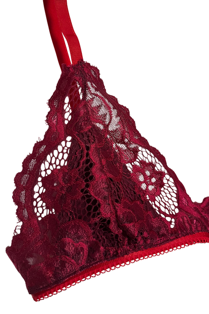 Close-up of an airy red wire-free lace triangle bralette showing floral lace texture and soft underbust elastic.
