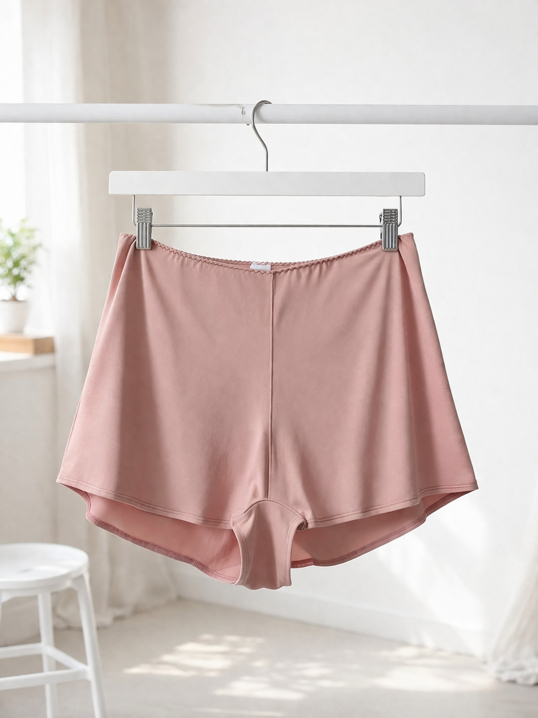 Cuurve Cosy Charlotte Shorts in Blush modal, hanging on a clothes hanger against a bright minimal background