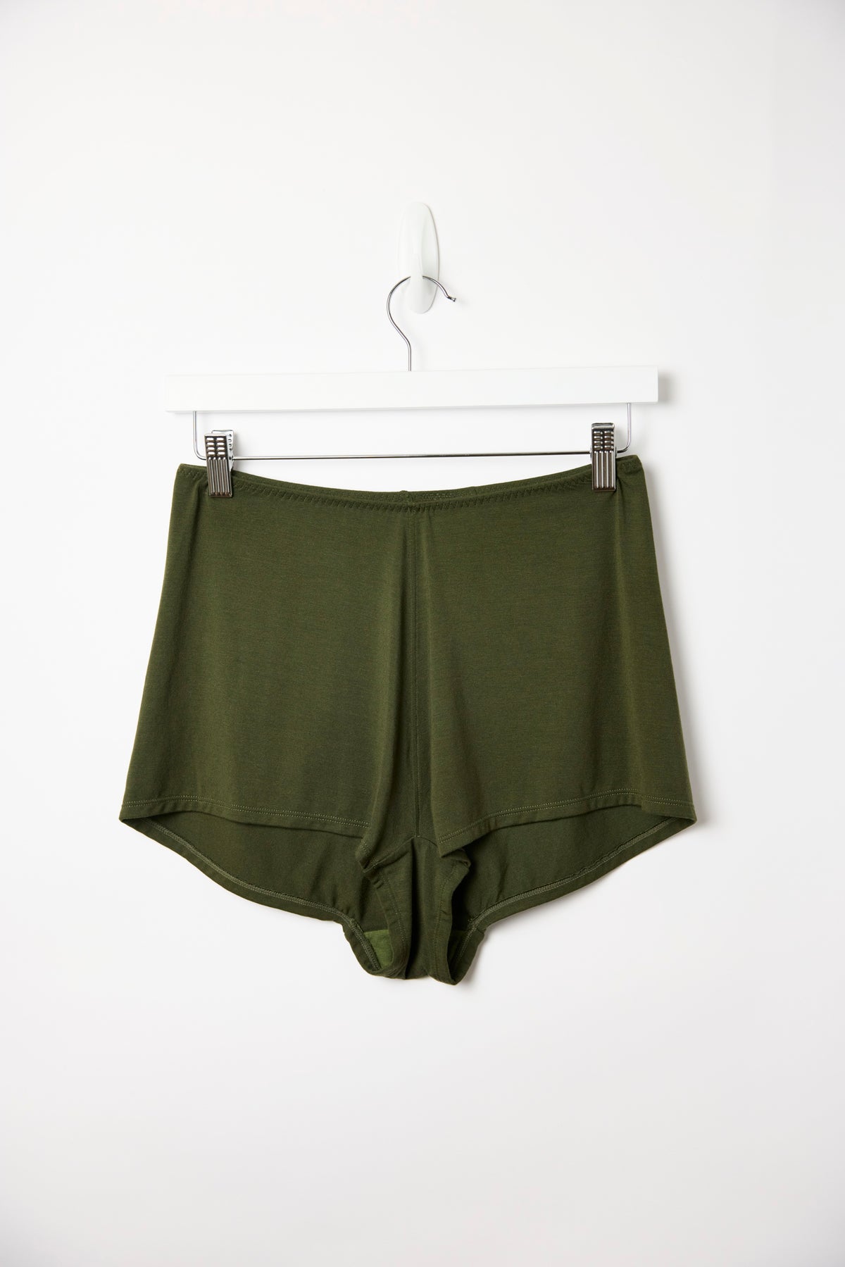Dark olive Cosy Charlotte shorts hanging on a white clip hanger against a plain white background