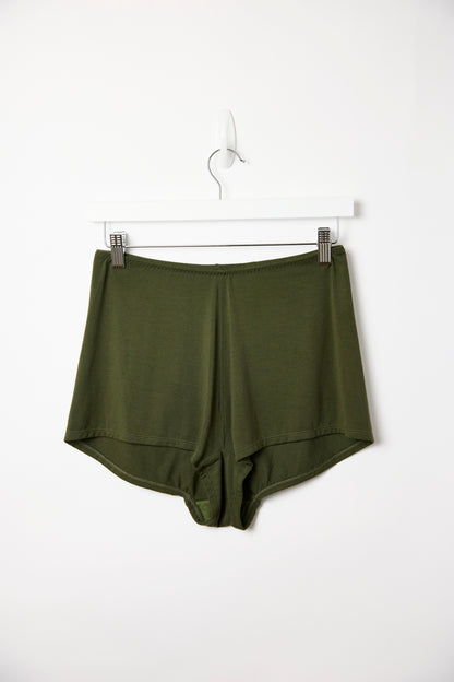 Dark olive Cosy Charlotte shorts hanging on a white clip hanger against a plain white background