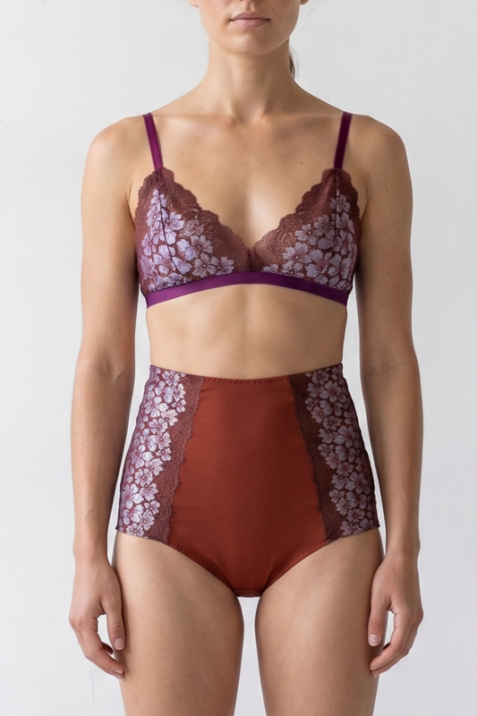 Woman wearing a floral lingerie set with a plain background