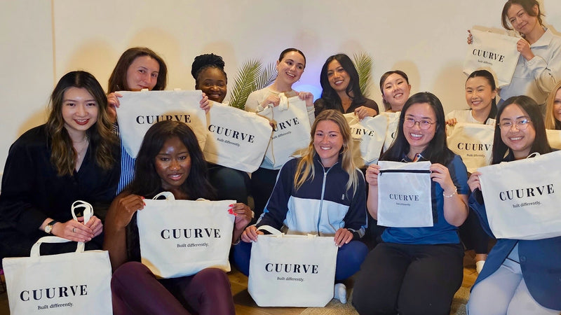 Group of people holding CUURVE bags in a store setting