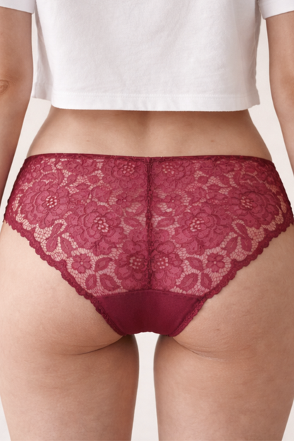 Back view of burgundy lace brief on model, featuring soft rounded lace that moves gently with bodies prone to swelling or sensitivity.