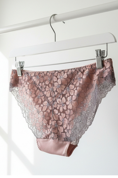 Handcrafted UK lingerie brief in blush pink, soft rose and silver dawn lace, Cuurve Sleek Sophie, hanging on rail in natural light