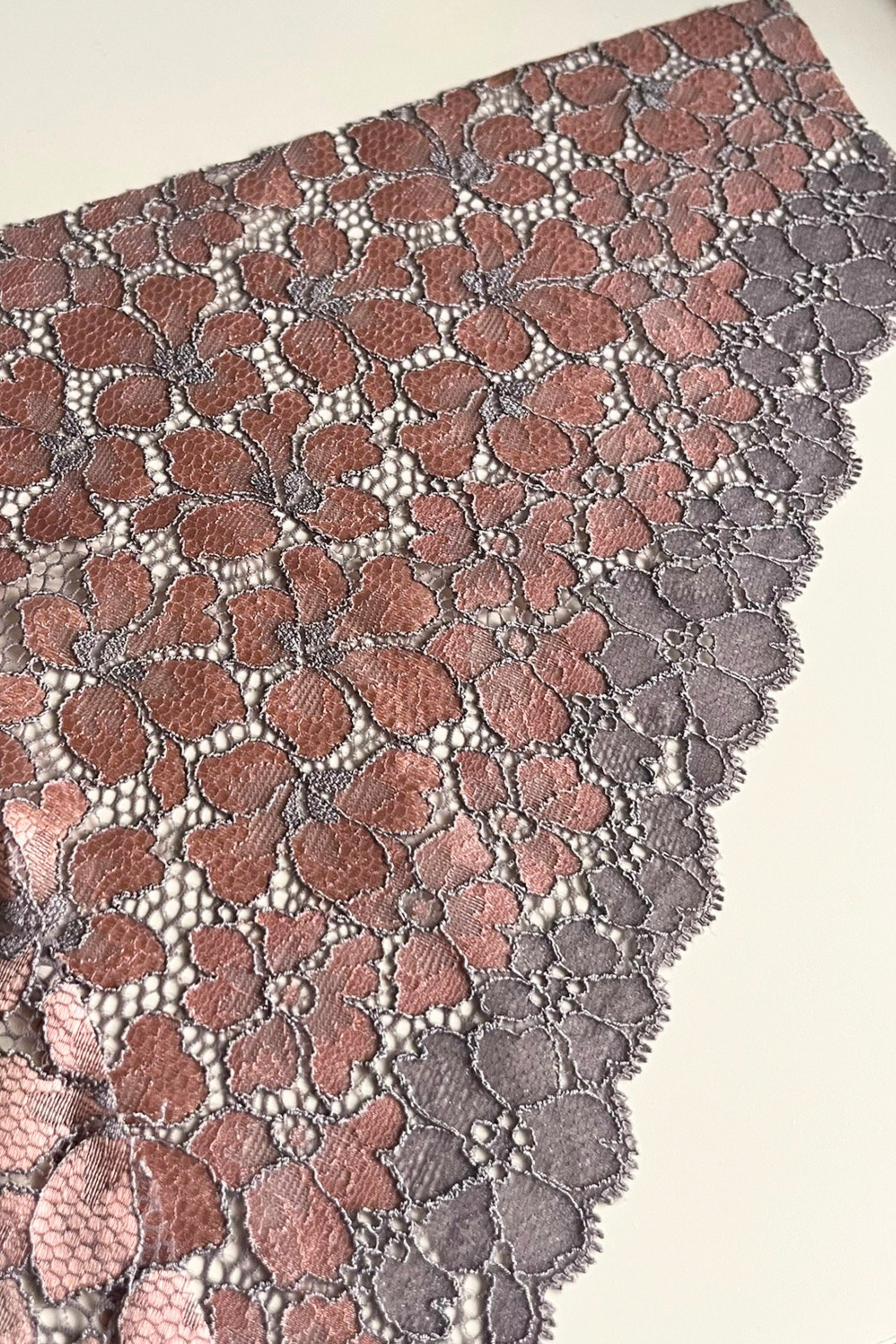 Handcrafted UK lingerie brief in blush pink, soft rose and silver dawn lace, Cuurve Sleek Sophie, flat lay on the table showing the lace detail 