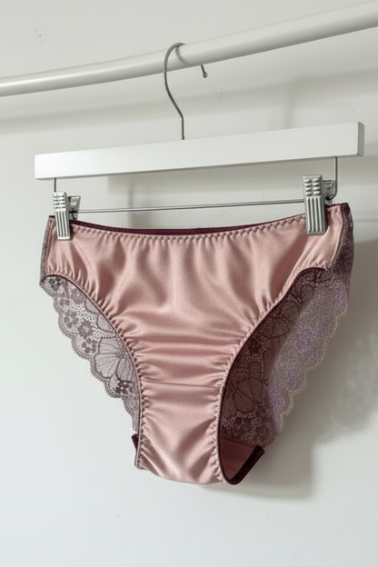 Handcrafted UK lingerie brief in blush pink and dusk lace, deep violet lace with gold trim detail, Cuurve Sleek Sophie, hanging on rail in natural light