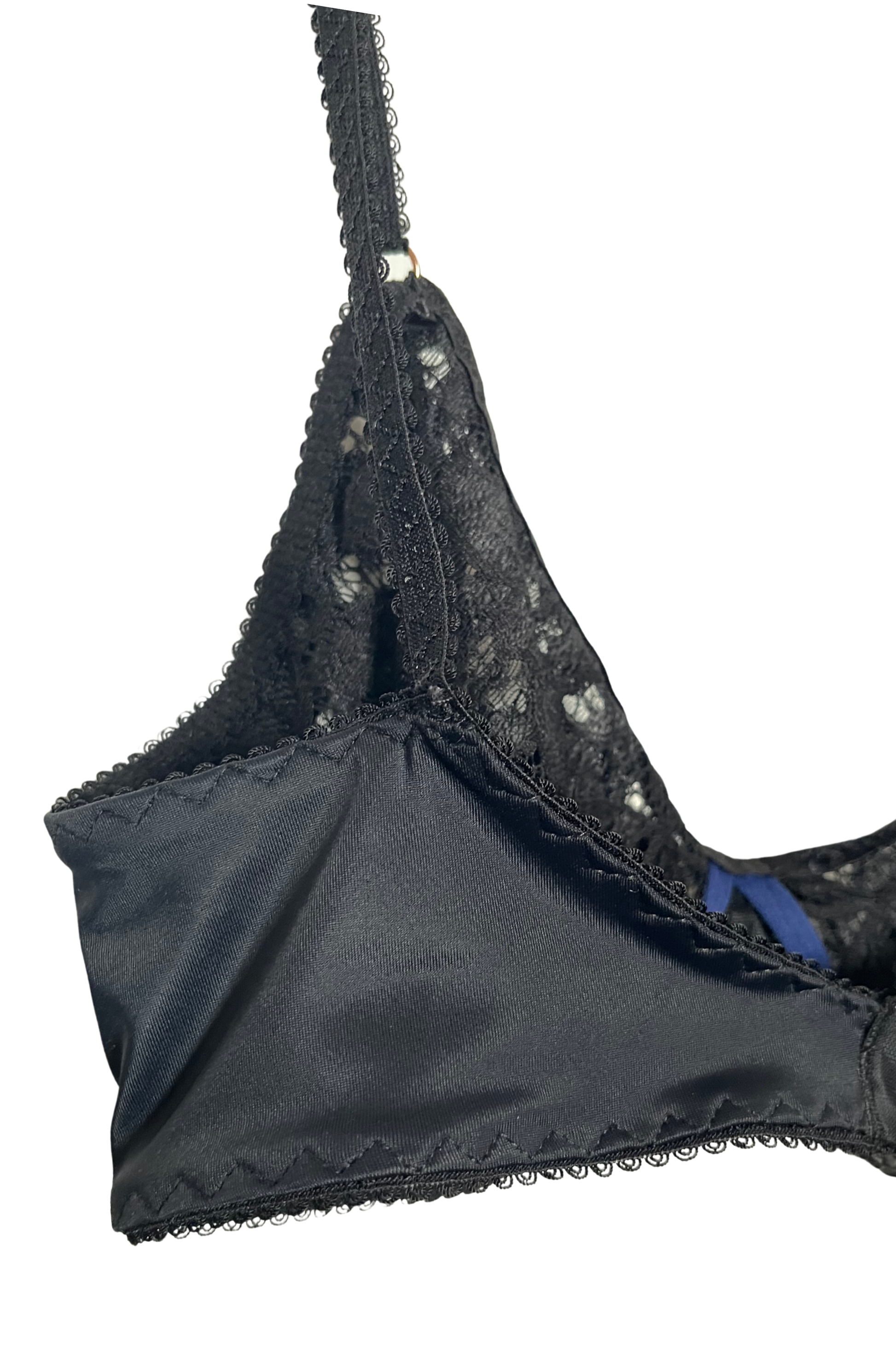 Close-up side view of a black wire-free lace bra showing lace lining and supportive wings made from Italian regenerated nylon.