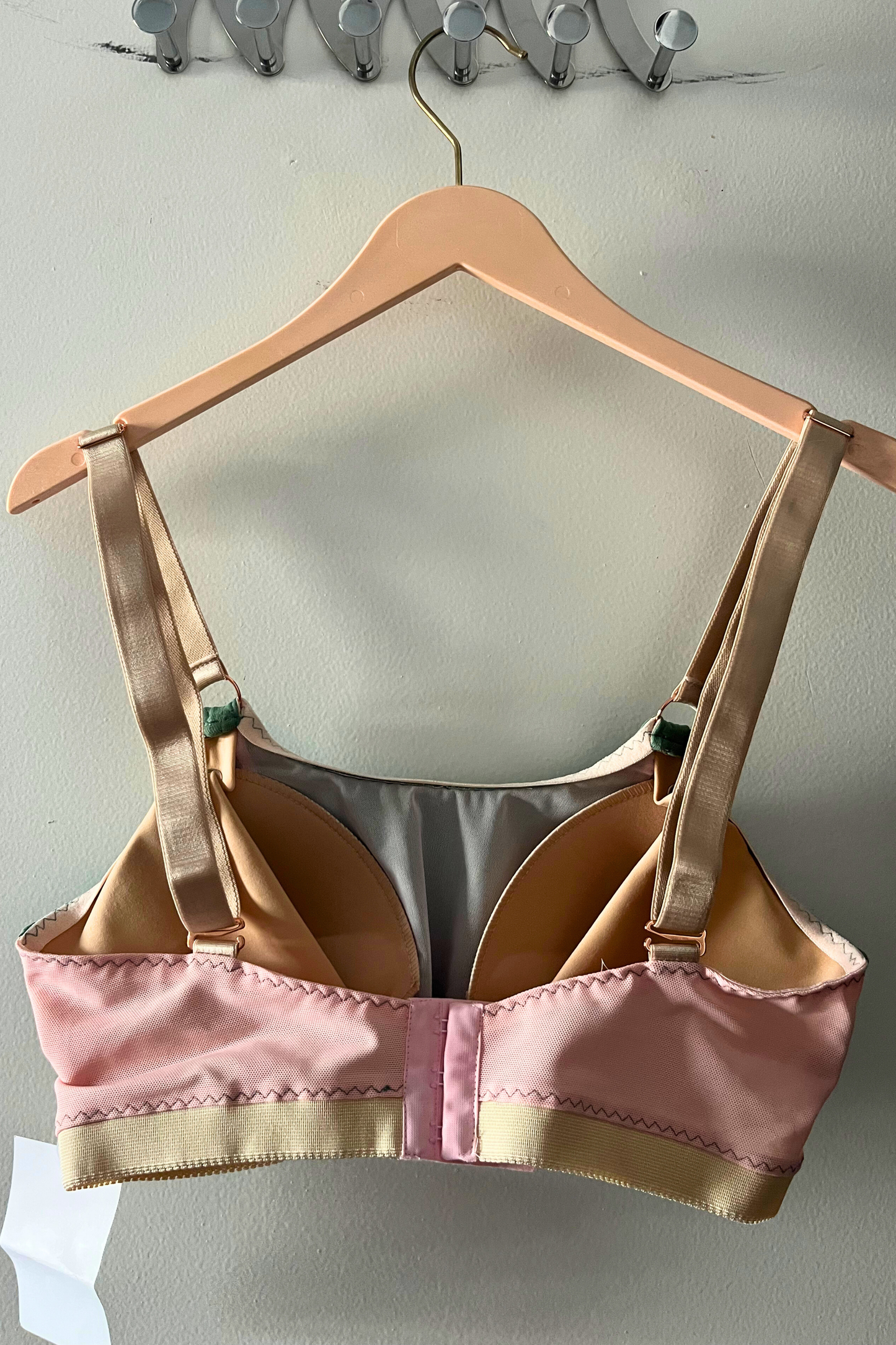 back view of the green dd+ bralette displaying the adjustable cross-back hooks, wide straps and supportive band.