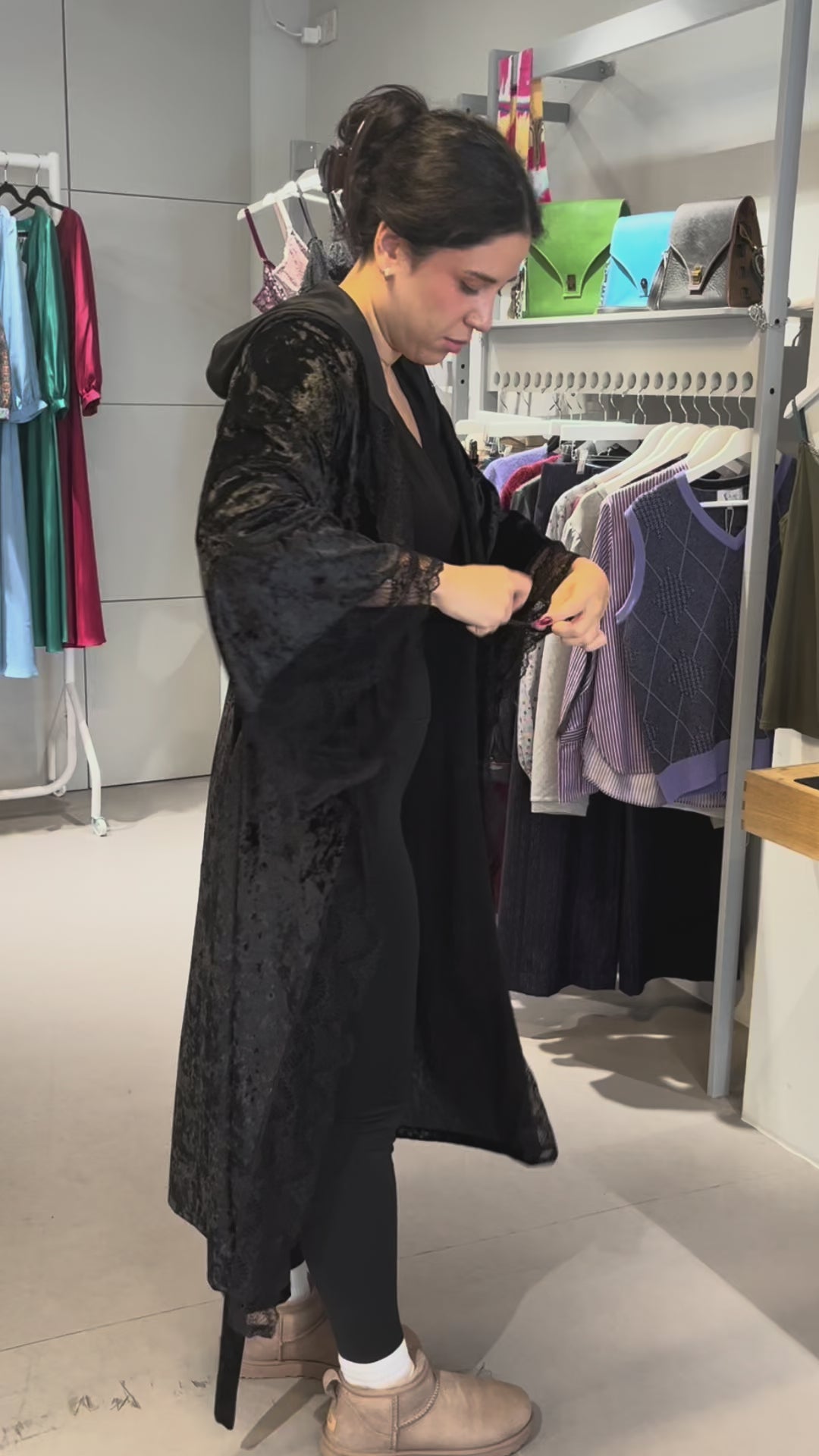 Video of the black crushed velvet romantasy gown being worn, showing the lace-trimmed hood and bell sleeves