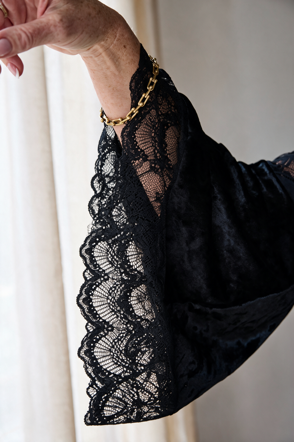 Close-up of the scalloped lace bell sleeve